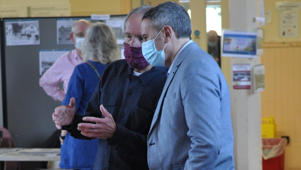 Two men chatting with face masks on